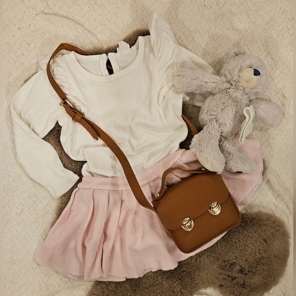 Pleated skirt and white onesie outfit